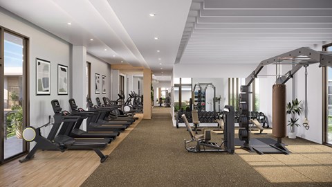 A well-lit gym with a variety of equipment.