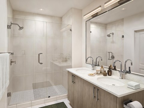 A modern bathroom with a walk-in shower and double sinks.
