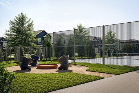 A playground with a fence and a green lawn.