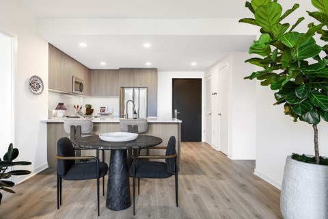 A modern dining room with a round table and chairs.