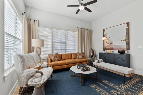 A living room with a chair, couch, and coffee table.