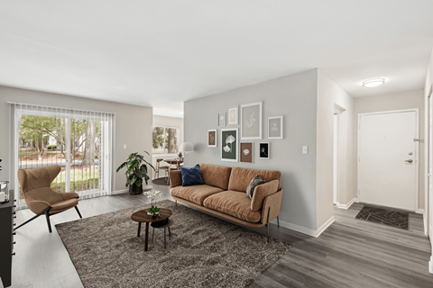 a living room with a couch and a chair and a rug