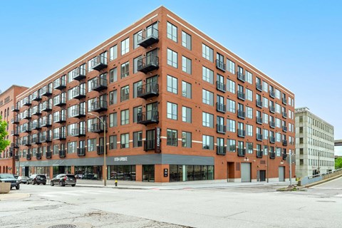A large red brick building with many windows and balconies.