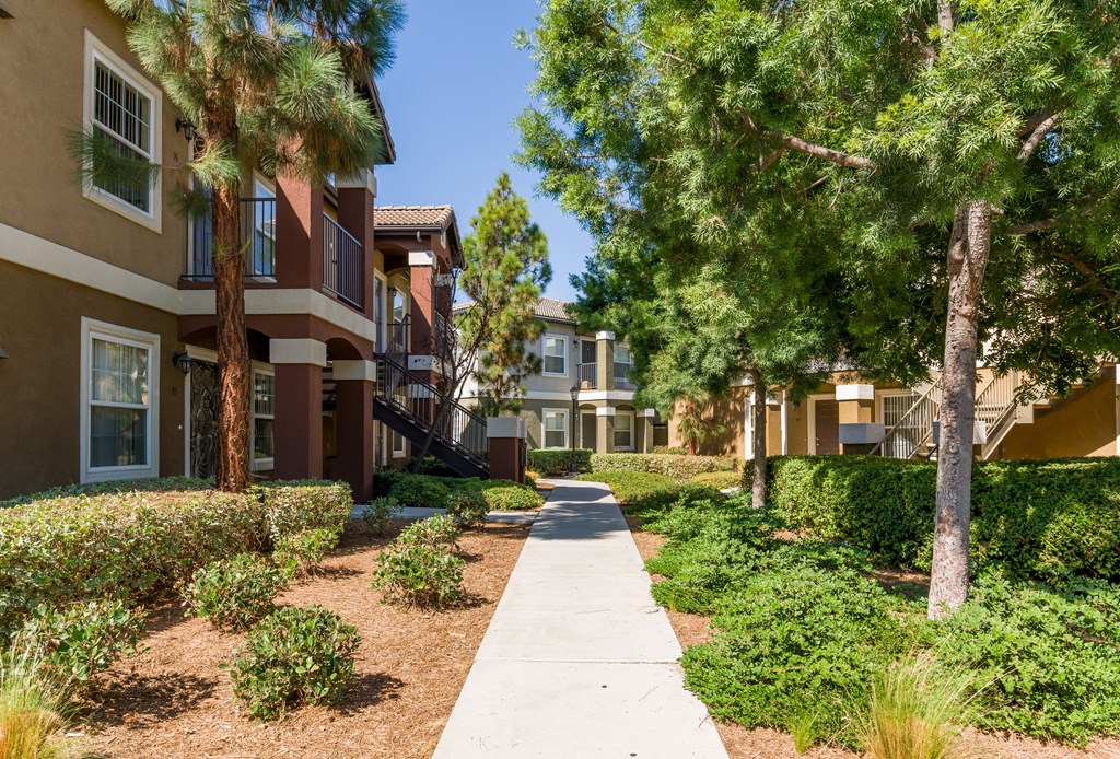 A row of houses with a sidewalk in between at The Landing at Ocean View Hills Apartments