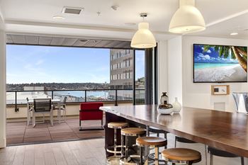 A modern bar area with a view of the cityscape.