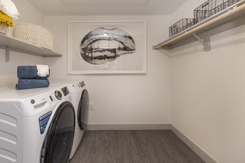 A small laundry room with a washer and dryer.