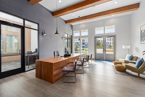A modern office with a wooden desk and chairs.