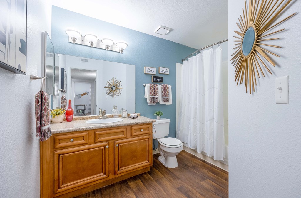 a bathroom with blue walls and a white shower curtain