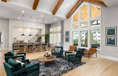 a living room with furniture and large windows