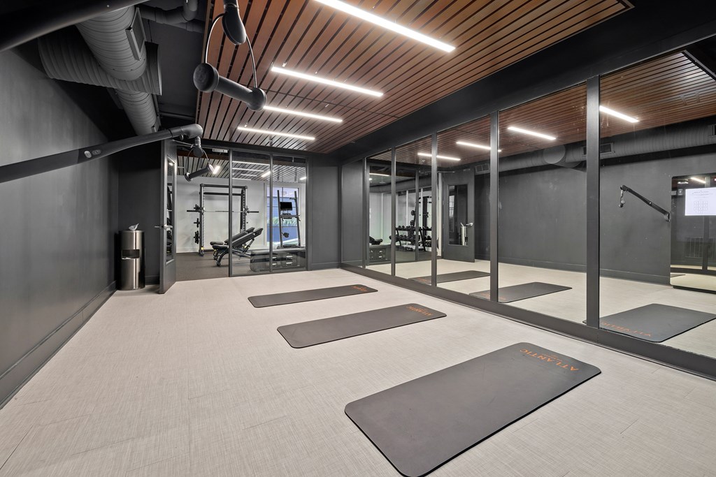 A gym with a row of mats on the floor.
