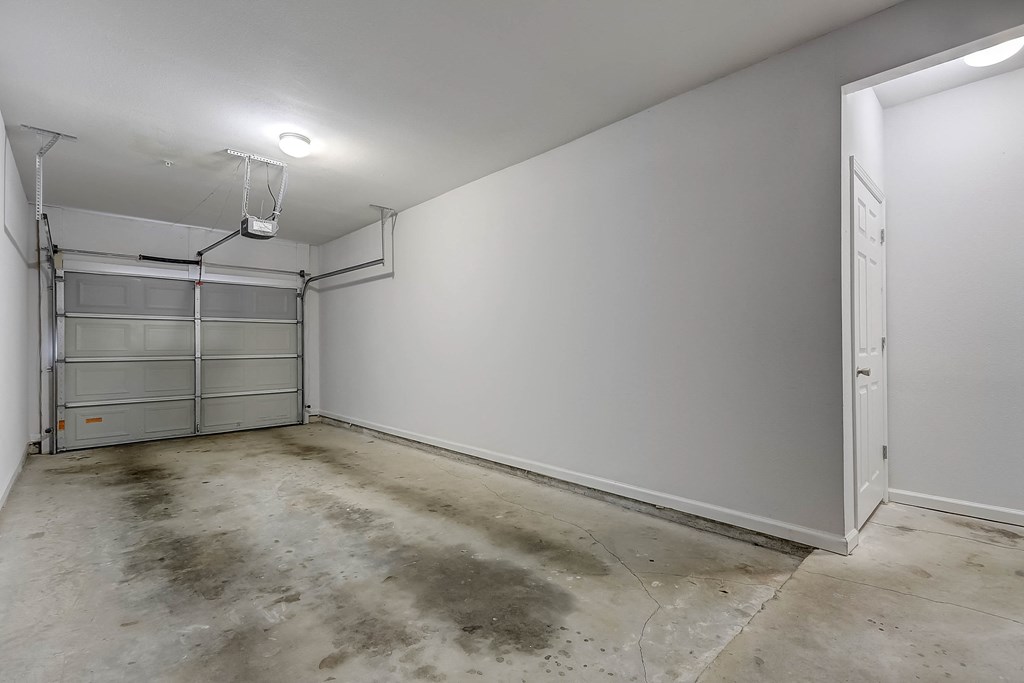 a large room with a concrete floor and white walls