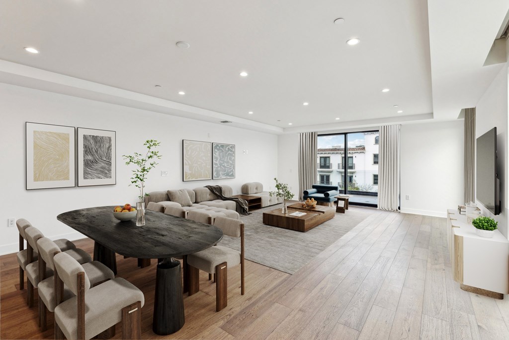 A modern living room with a black table and grey couches.