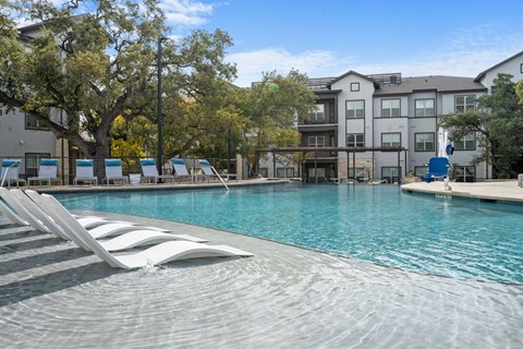 A large swimming pool with steps leading into the water.
