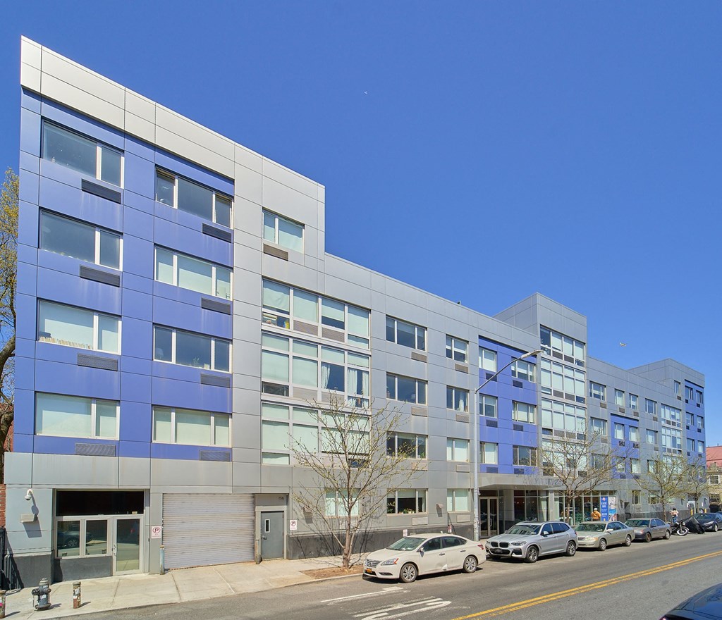 a large blue and white building on a city street