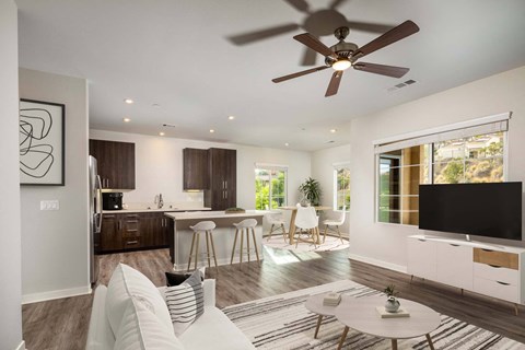 Lakeview 88 - Living room with a ceiling fan and a kitchen in the background