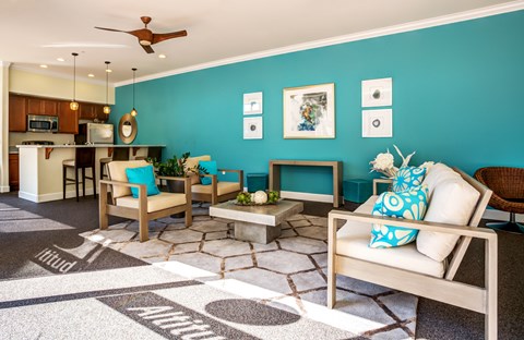 A living room with a white couch and a rug with the word "ANIMAL" on it.