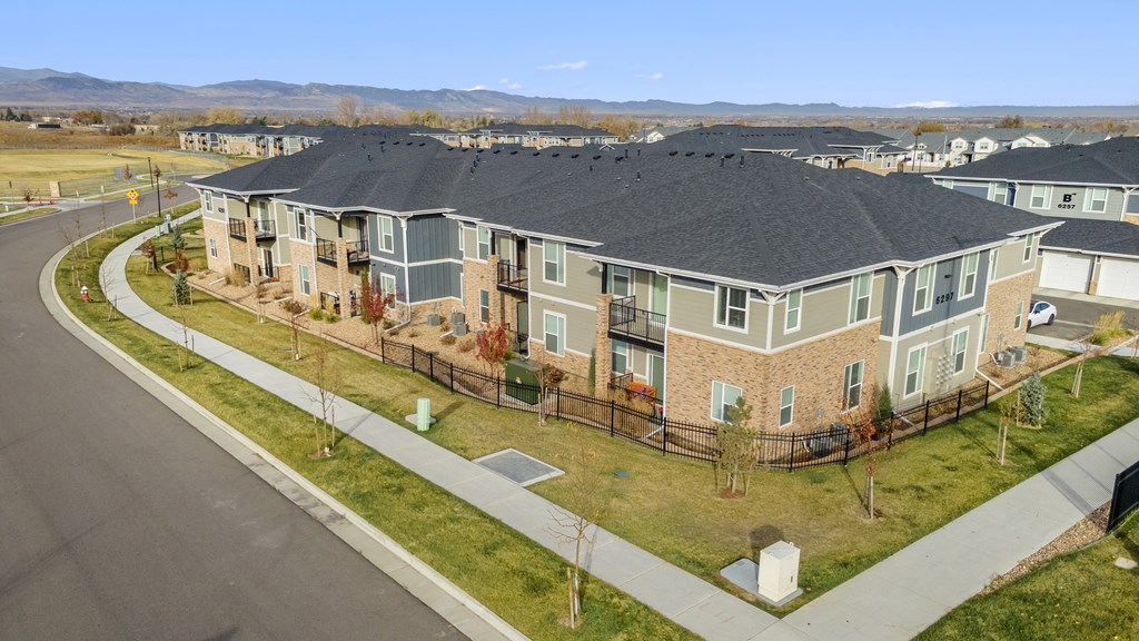 an aerial view of a row of houses on a street