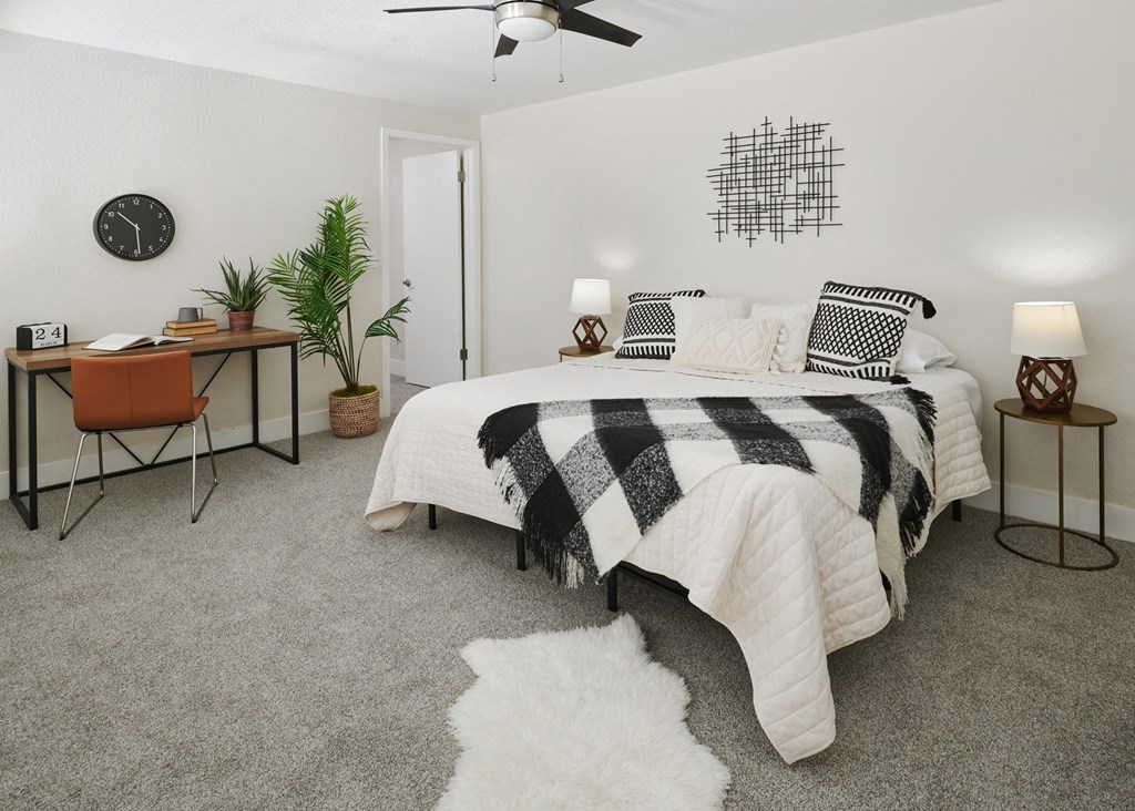 a bedroom with a bed and desk in a 555 waverly unit