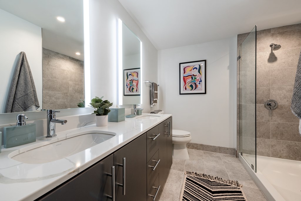 A bathroom with a white sink and a toilet.