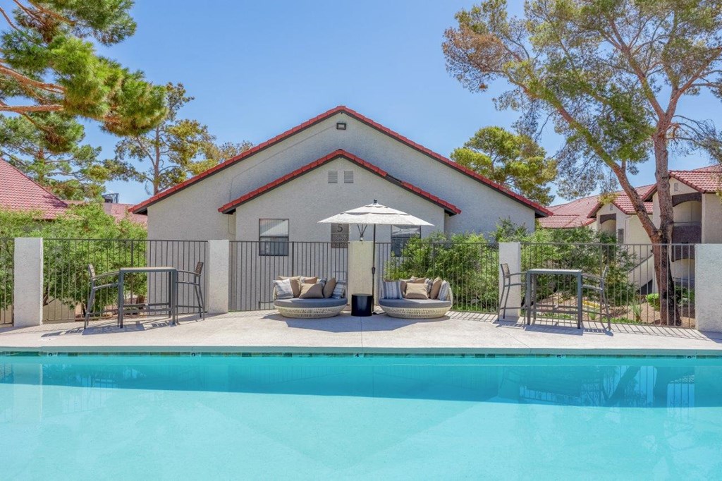 a pool with chairs and an umbrella