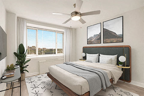 a bedroom with a bed and a ceiling fan