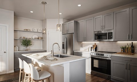 A modern kitchen with a white countertop and stainless steel appliances.