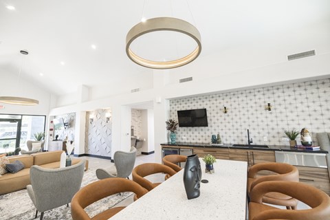 A modern dining area with a white table and chairs.