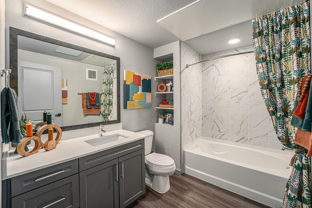 a bathroom with a shower and a sink and a toilet