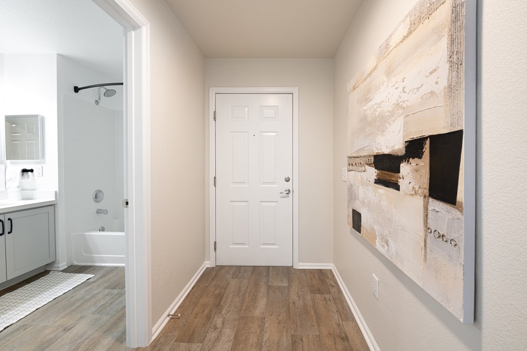 A white door is in the middle of a hallway.