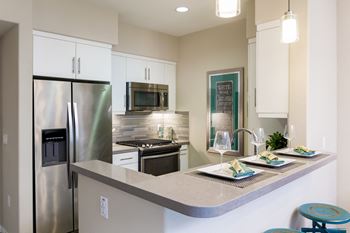 Underlit Cabinets in kitchen with stainless appliances at Avino in San Diego, CA 92130