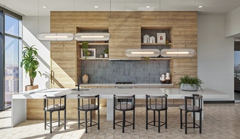a modern kitchen with a large island and stools