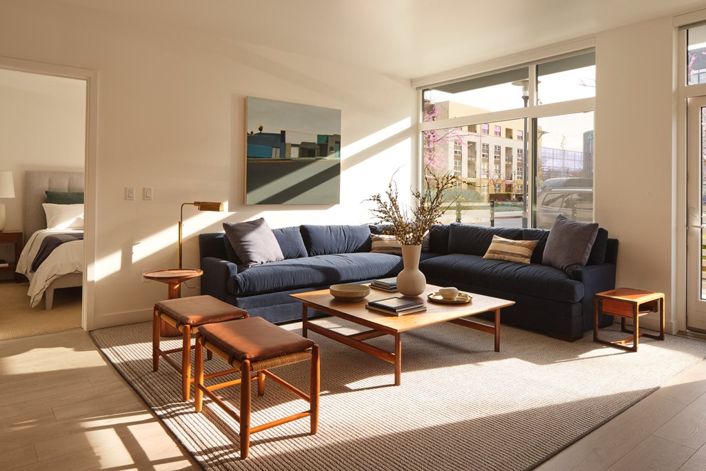 a living room with a blue couch and a coffee table