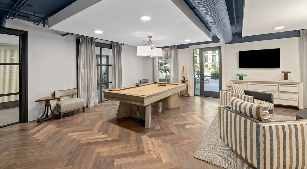 A living room with a wooden floor and furniture.