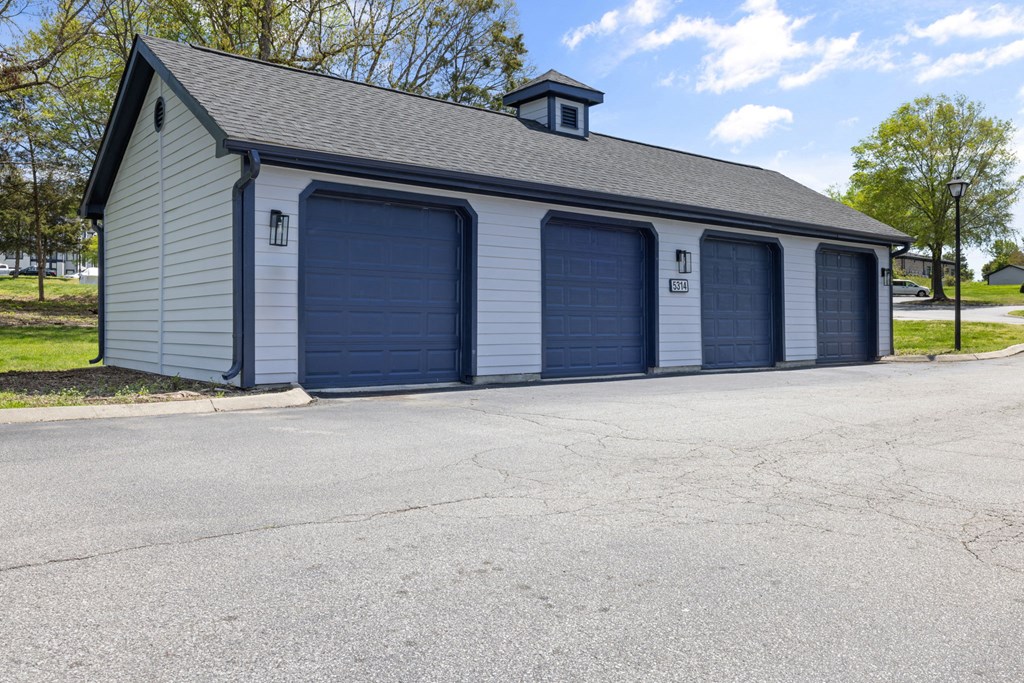 a garage with 4garages in front of a house at The Madison at Adams Farm, Greensboro, NC