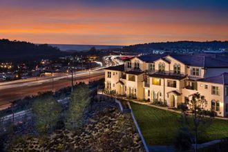 an aerial view of Ocean Air Apartments overlooking the freeway at dusk in San Diego, Ca