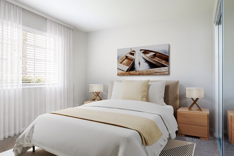 A bedroom with a large bed and a painting of boats on the wall.