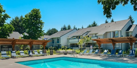 Pool deck with lounge chairs and pergolas at Brookside112 Apartments, Vancouver, Washington