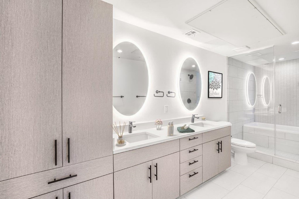 a bathroom with two sinks and a toilet