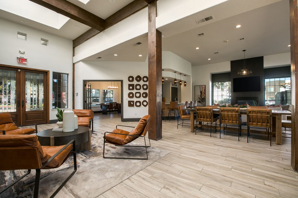 the lobby of a clubhouse with tables and chairs