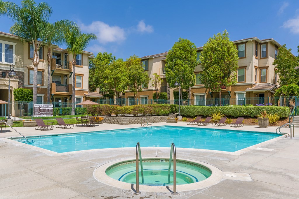 A swimming pool in front of apartment buildings.