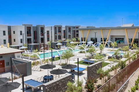 A sunny day at the resort style pool and apartments in the background.