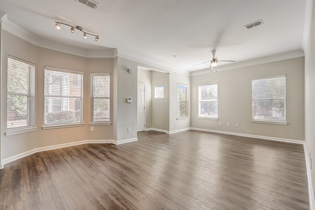 an empty living room with hardwood floors