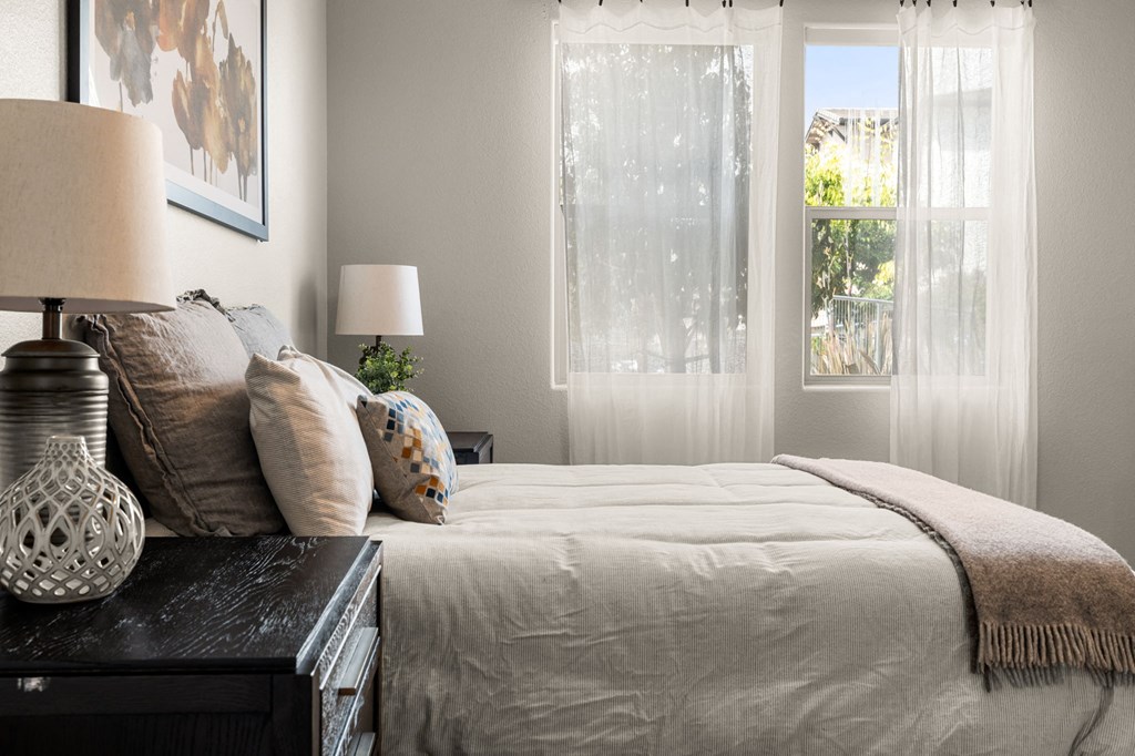 a bedroom with a bed and a window