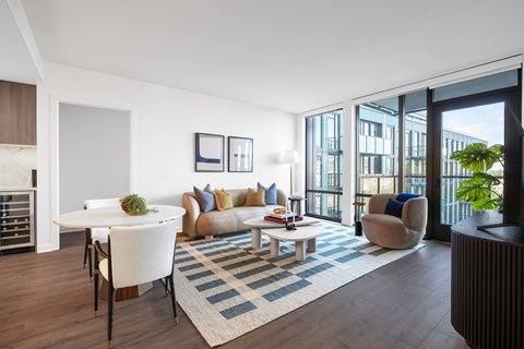 A living room with a white couch and a coffee table.