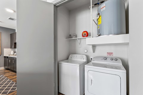 A washing machine and dryer are in a small laundry room.