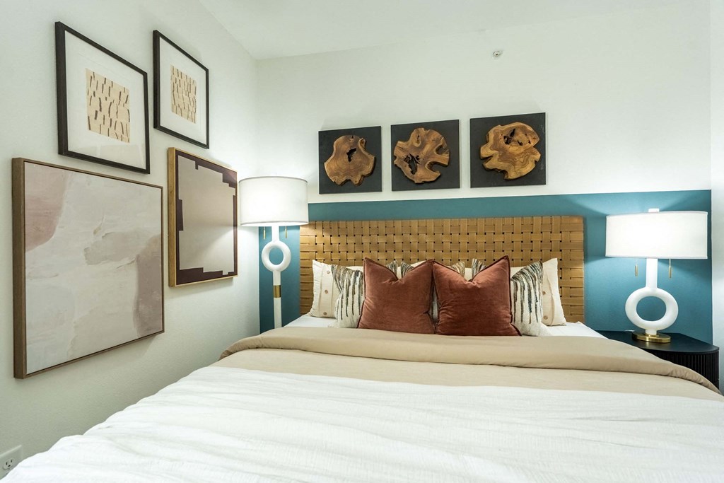 a bedroom with a bed and pictures on the wall