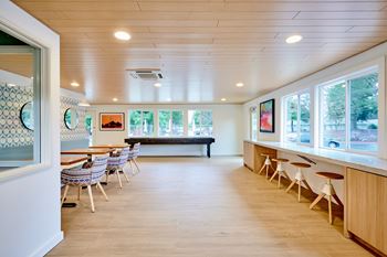 A room with a long table and chairs.