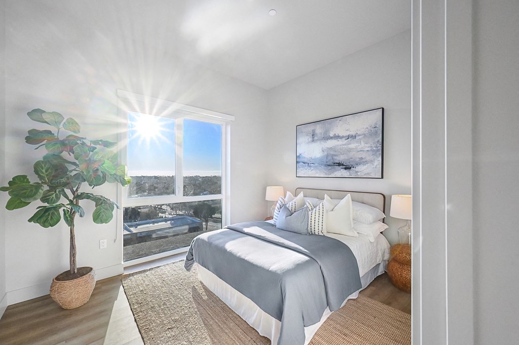 a bedroom with a bed and a large window