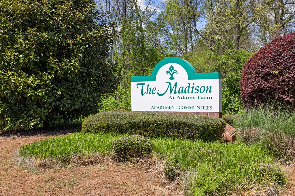 the sign for the madison at adams farm apartments