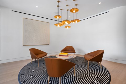 A seating area in the leasing office with a round table and chairs.